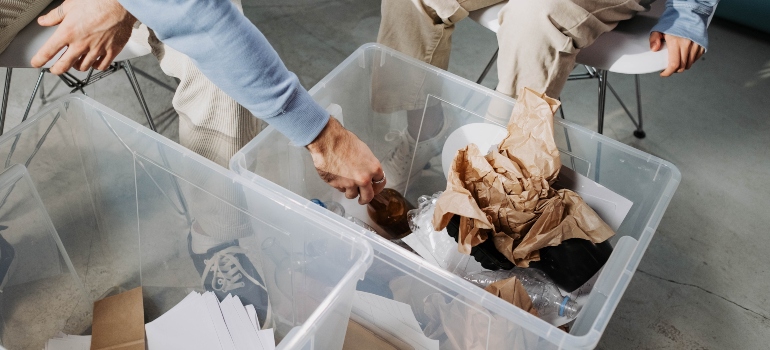 people packing items in plastic boxes