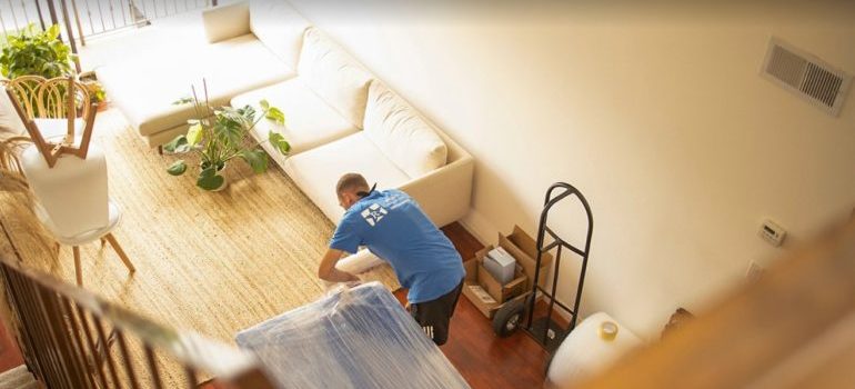 one of residential movers Dallas–Fort Worth metroplex packing things in loving room