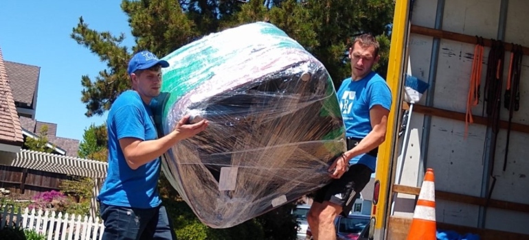 Two movers lifting furniture