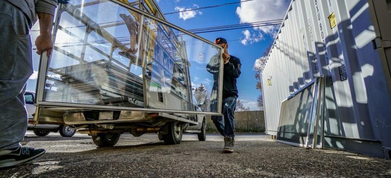 movers transporting some window frames.