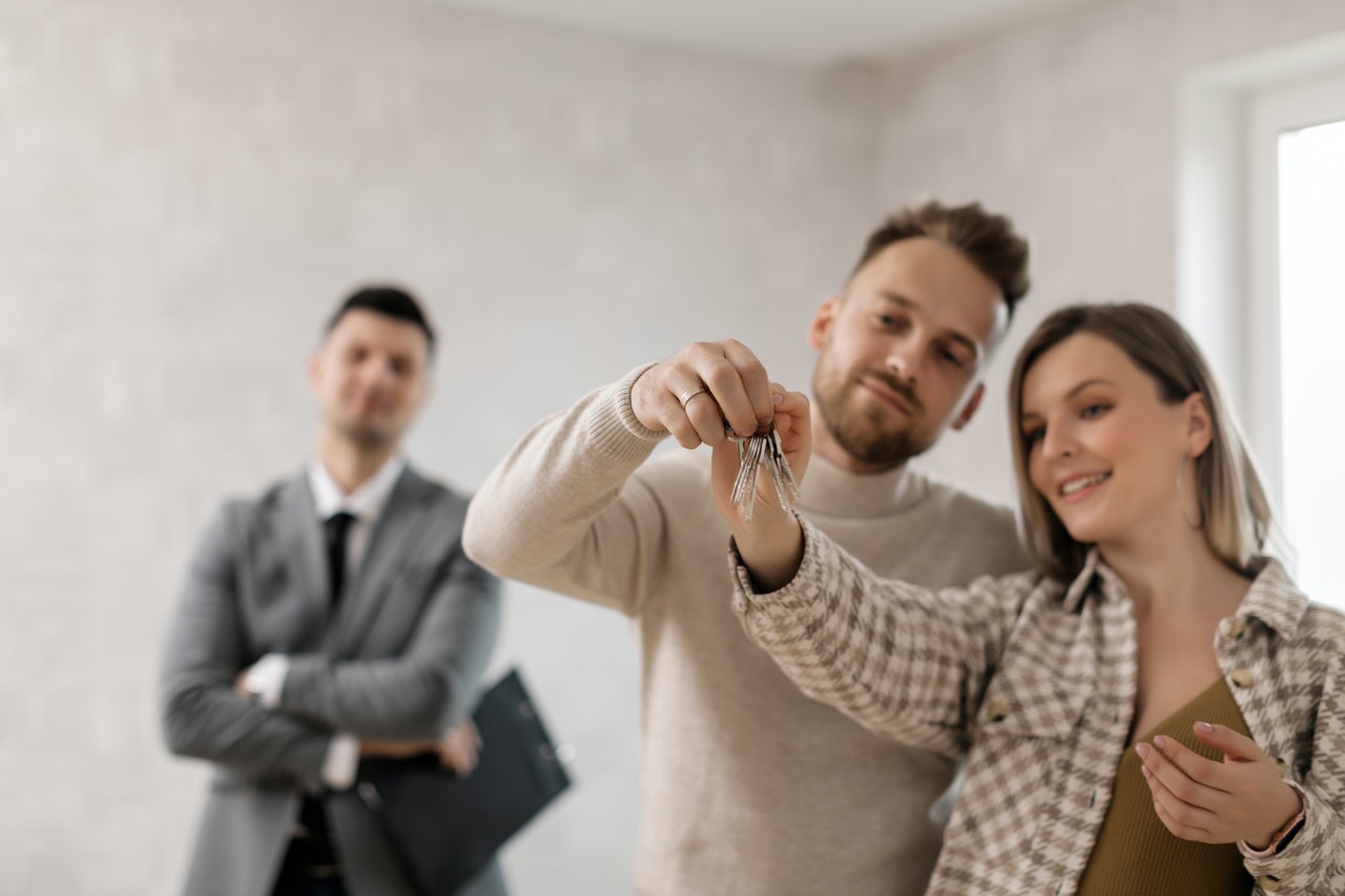 a couple holding keys