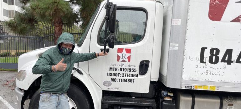 one of Beverly Hills movers holding Rockstar moving truck 