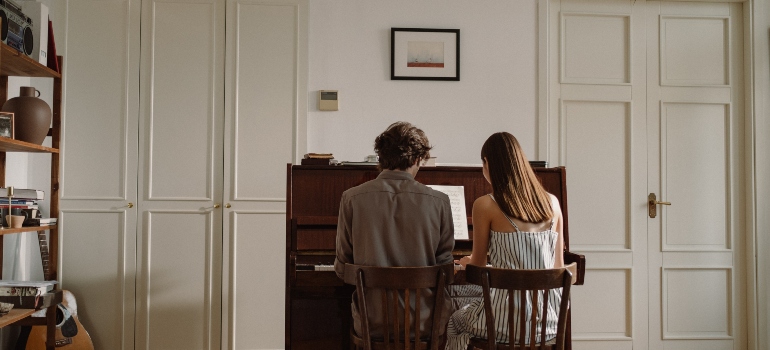 couple playing after moving a piano in Dallas–Fort Worth metroplex