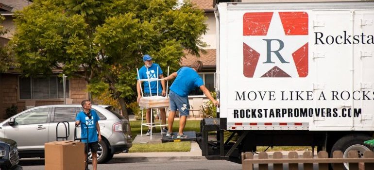 Houston movers lifting furniture into a truck