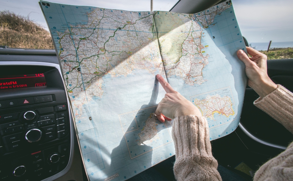 woman holding her finger on the map