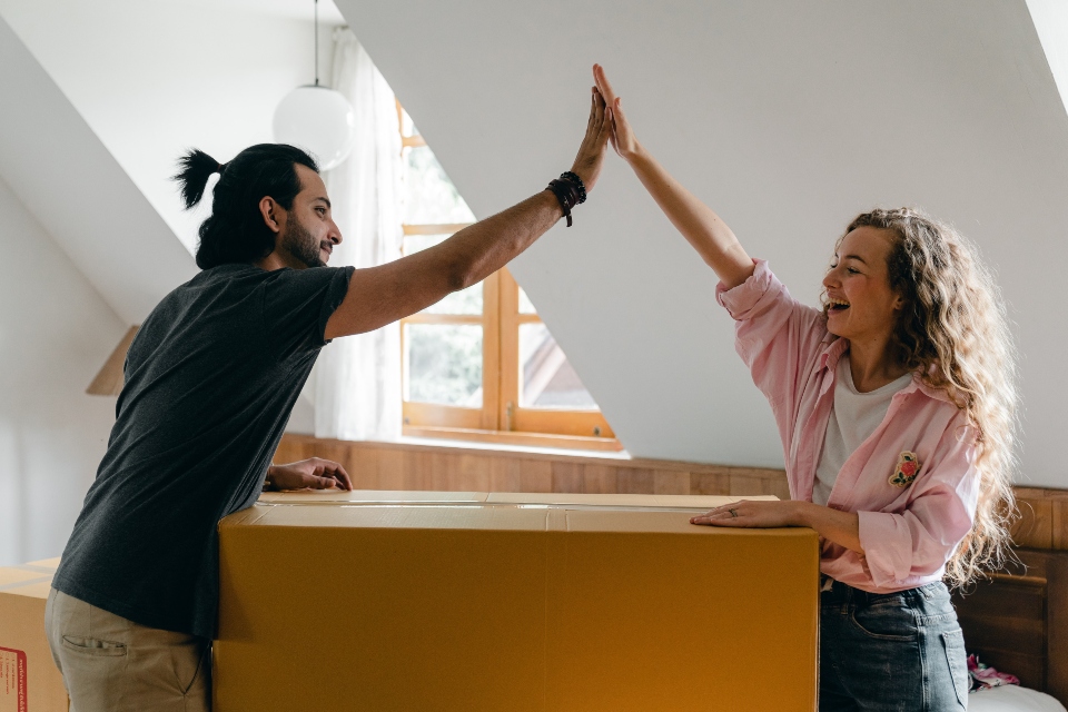 couple giving each other high five after successfully moving from Phoenix to San Diego