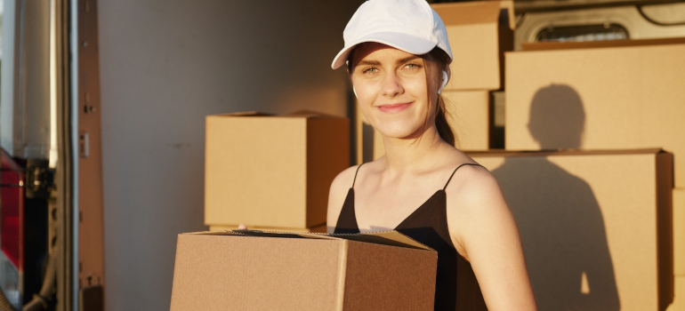 a girl holding boxes