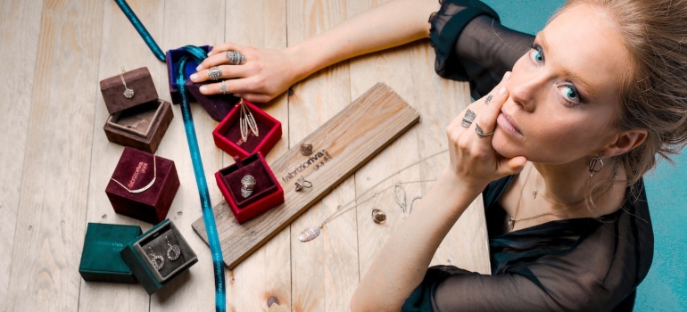 a woman sitting at the table with her valuable jewelry on the table