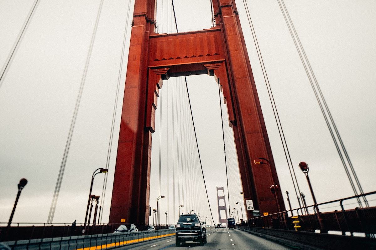 Modern cars driving along suspension bridge