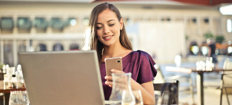 Young woman using a laptop to research how long is adjusting to life after moving from Texas to a New State going to take