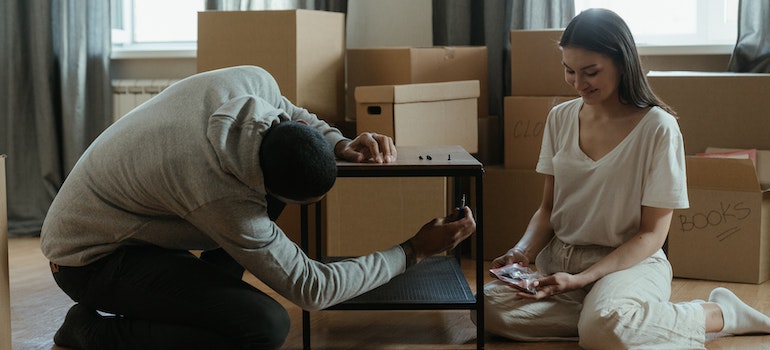 Man and woman dissasembling furniture