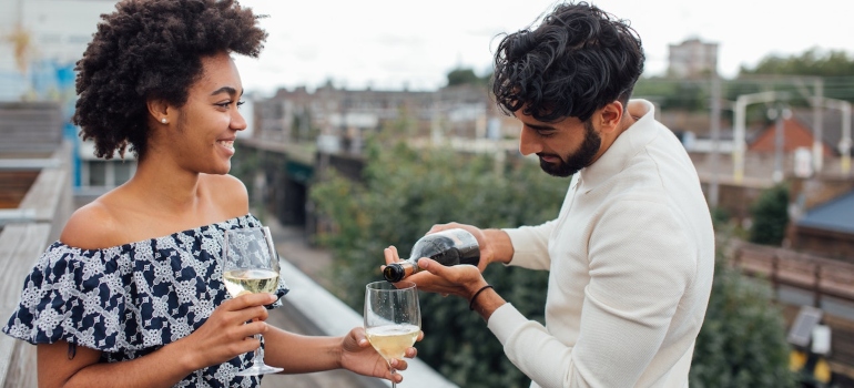 A man pours a drink on a woman in class