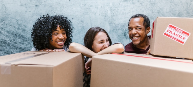 happy people surrounded by boxes