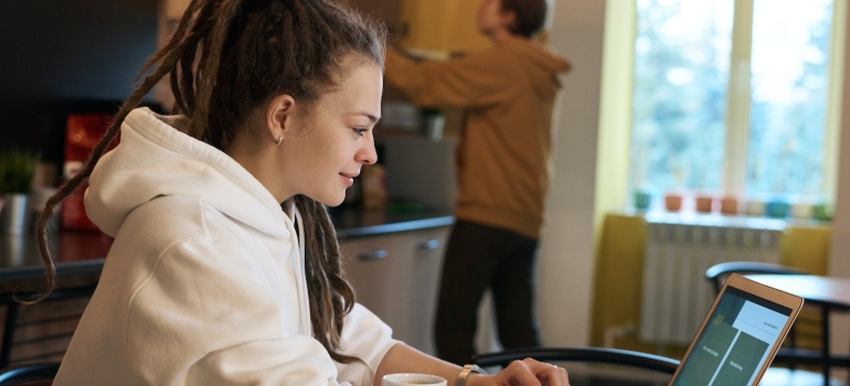 A young woman searching the net for where do young adults live in Austin