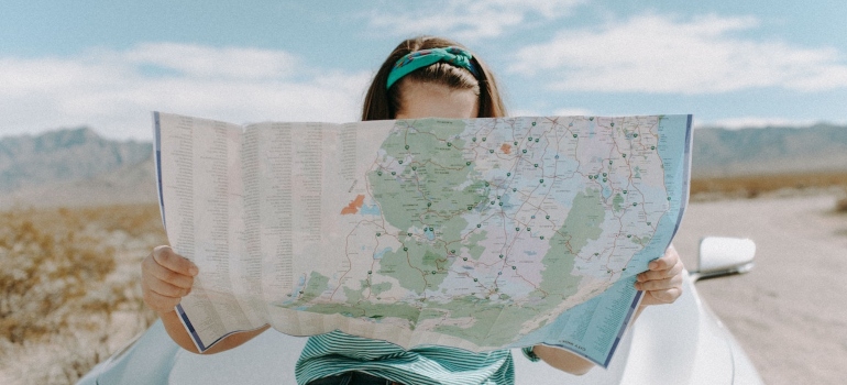 A woman using a map as a guide to navigating LA's crazy traffic