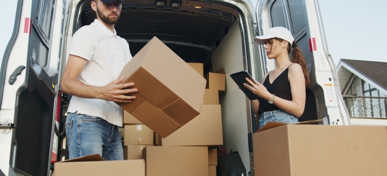 Picture of a couple loading boxes in a truck