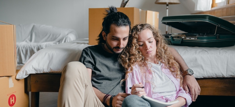 Picture of a couple who is trying to inventory your items when packing for a move