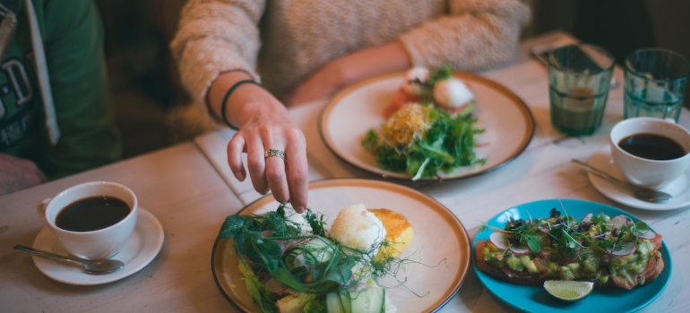 A woman eating in one of the best vegan restaurants in LA