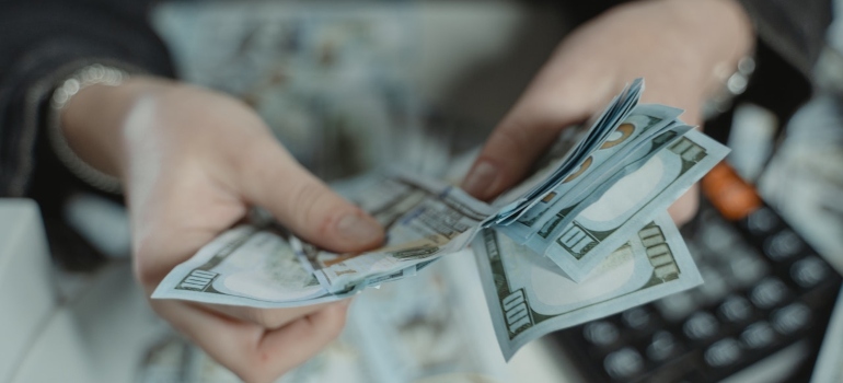 Picture of a person counting money in order to afford discovering the best San Fernando Valley neighborhoods on their own