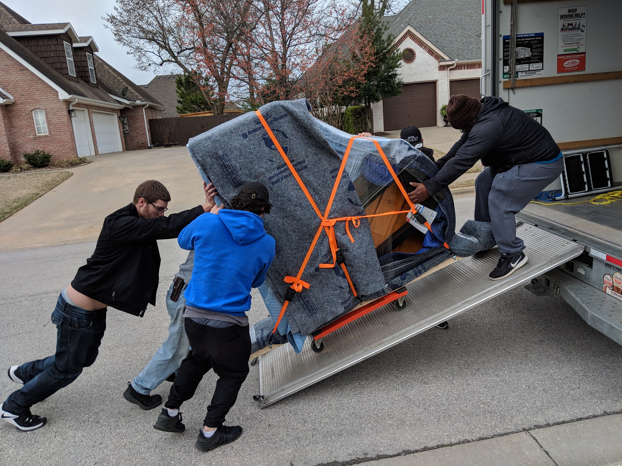 a mover carrying things on a dolly in front of the truck provides packing services Dallas–Fort Worth metroplex